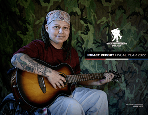 Wounded warrior Angie Lupe sits in a wheelchair and plays guitar.
