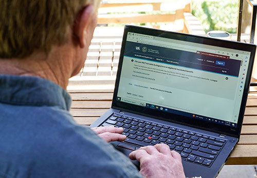 A veteran looking at the VA disability benefits webpage.