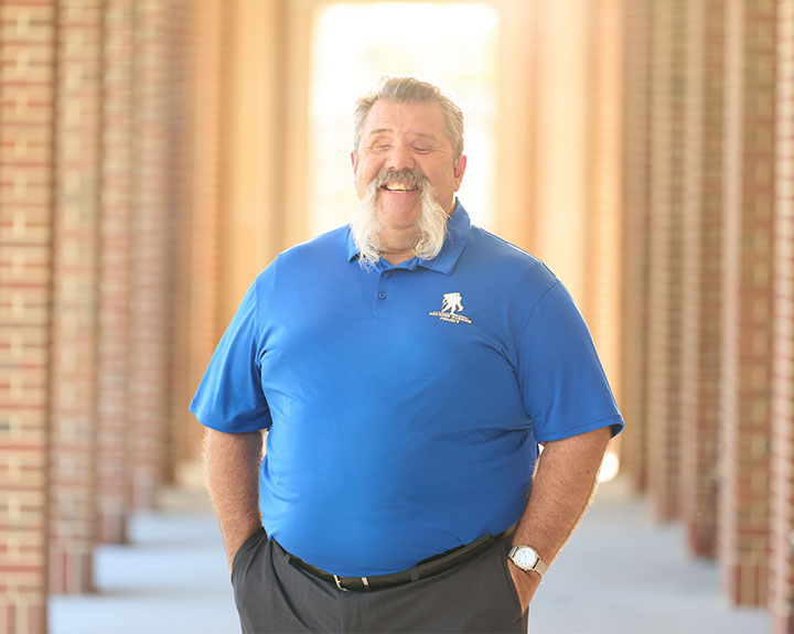 Wounded warrior Aaron Cornelius wearing a WWP blue Polo and smiling.