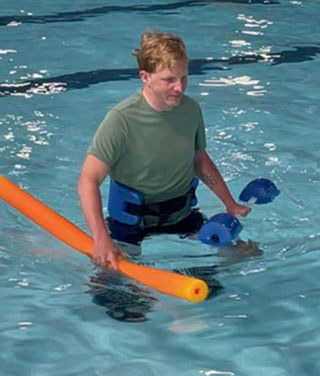Garrett Seifert does physical therapy in a pool.
