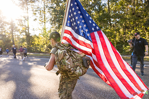 Participants in Wounded Warrior Project's Carry Forward event in Jacksonville, Florida, wave small flags in support of warriors.