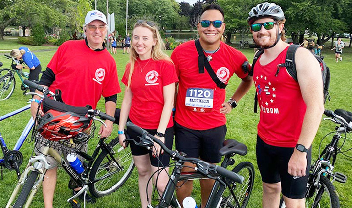 A group of Soldier Ride participants with the team name Wilson's Warriors, wear red to show support for their family member, USMC LCpl Justin J. Wilson.