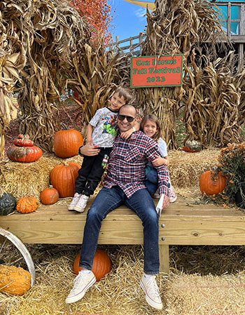 Marine veteran Juan Valdez with his children at a pumpkin field.