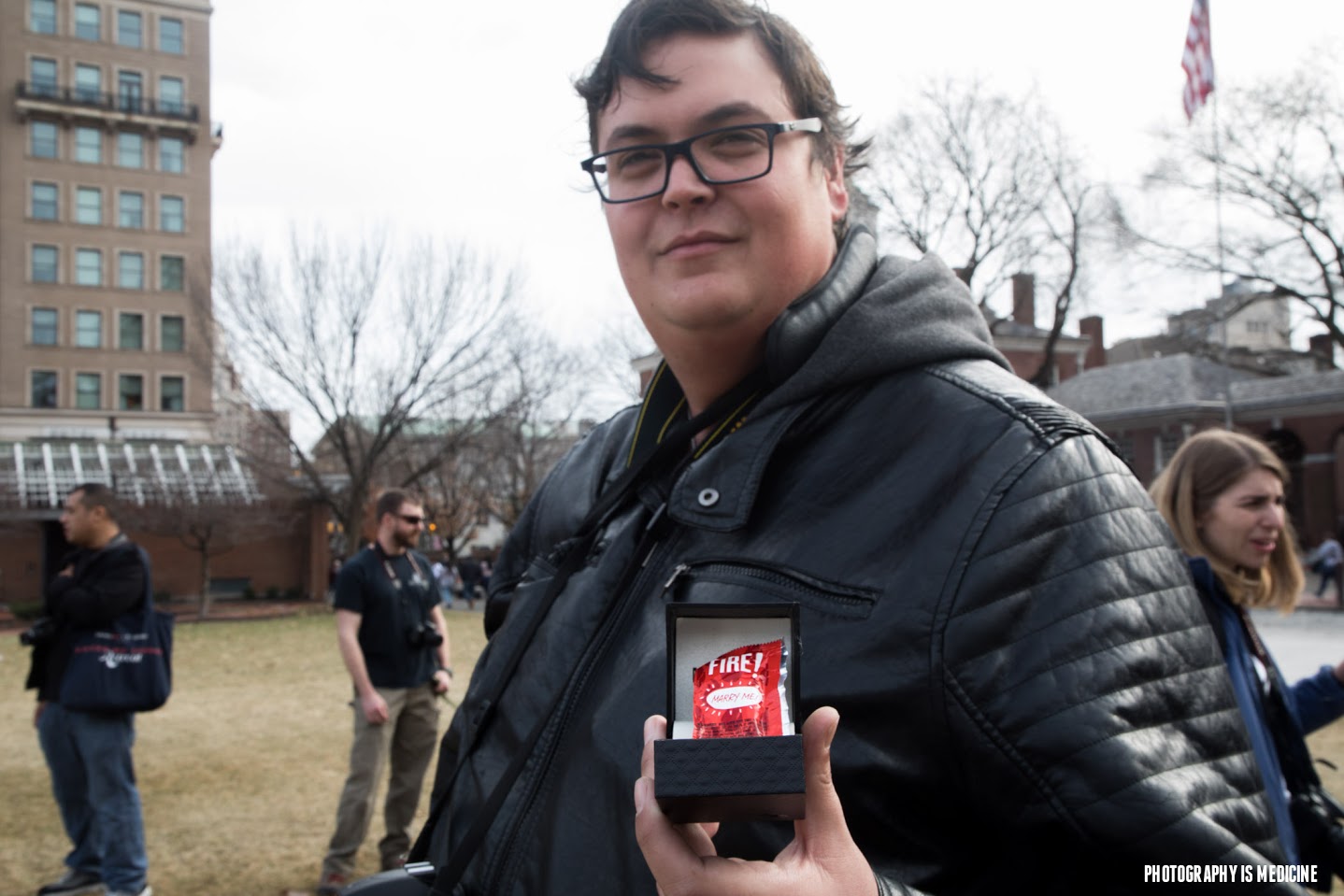 Frank Carr shows off the ring and hot sauce packet he used for a surprise proposal to Army veteran Briana McCrae.