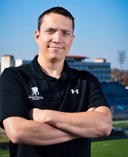 Man smiling at camera with arms crossed
