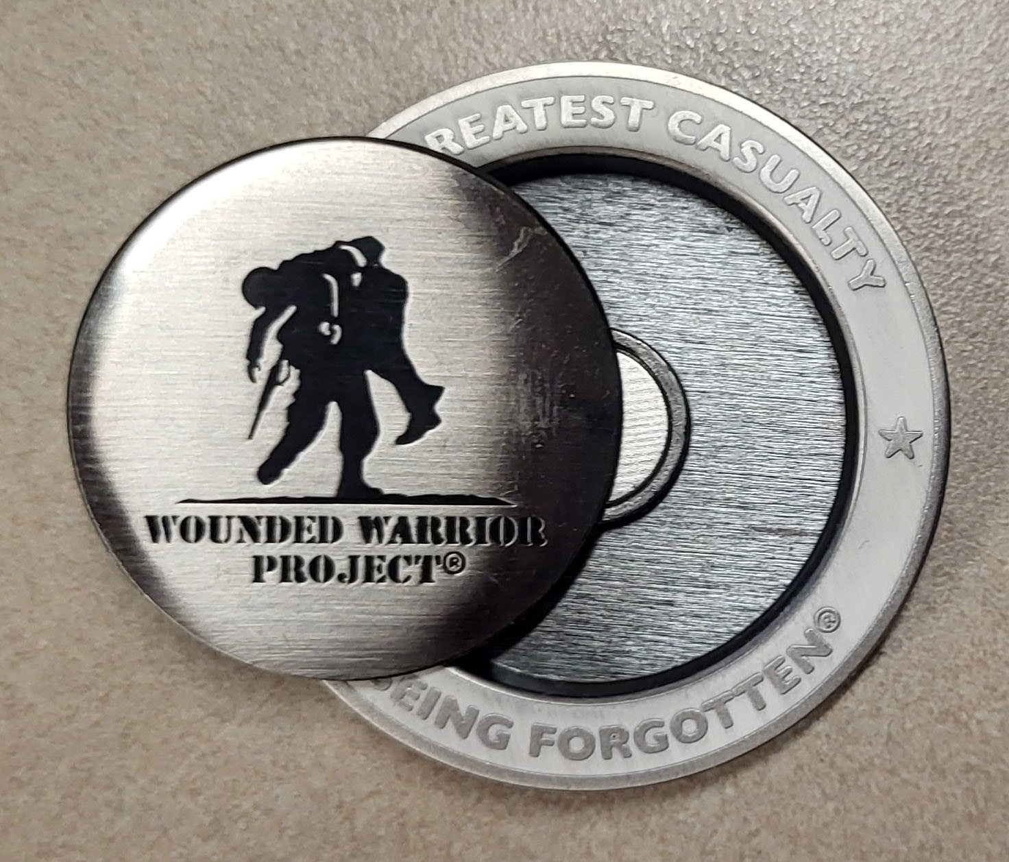 A WWP challenge coin that also serves as a golf ball marker 