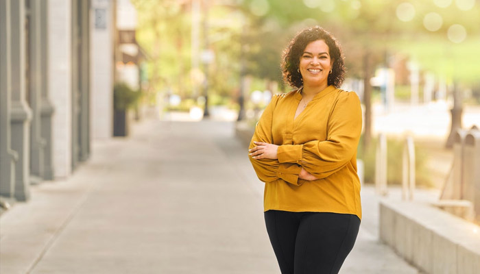 Warrior Yomari Cruz poses on a sidewalk 