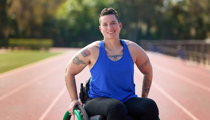 Wounded Warrior Beth King poses at a track