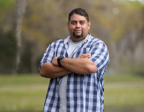 Wounded warrior Tim Aponte standing outside.