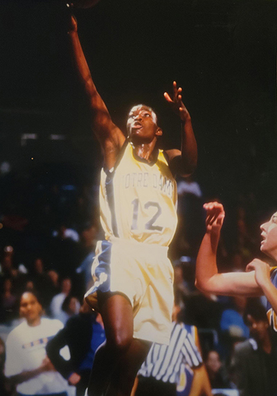 Danielle Green drives to the basket while playing basketball at Notre Dame.