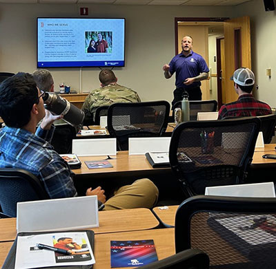 A WWP Benefits staff member talk to service members about transitioning at an Air Force base in Alaska.