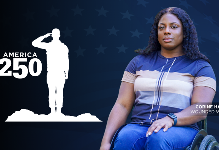 Warrior Corine Hamilton is seated in a wheelchair facing forward. A white graphic of a saluting soldier appears beside the text “America 250.”