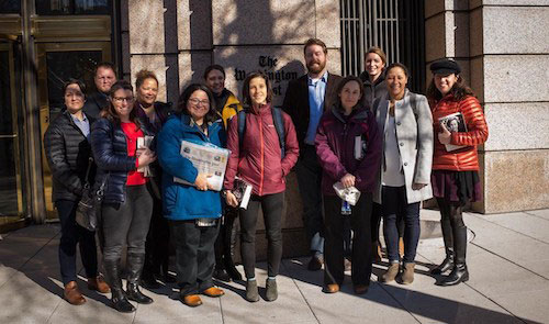 Participants from a writing seminar hosted by The War Horse stand outside the Washington Post building.