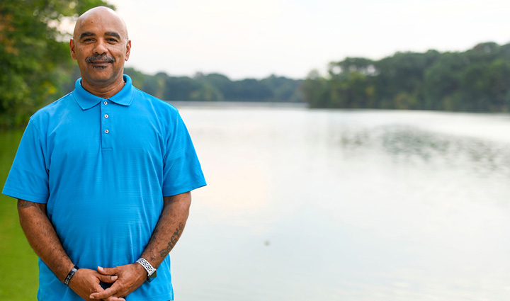 Warrior Bill Thomas standing in front of a lake.