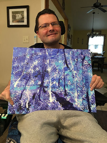 Army veteran Brian Zreliak poses with a piece of touch artwork he did.