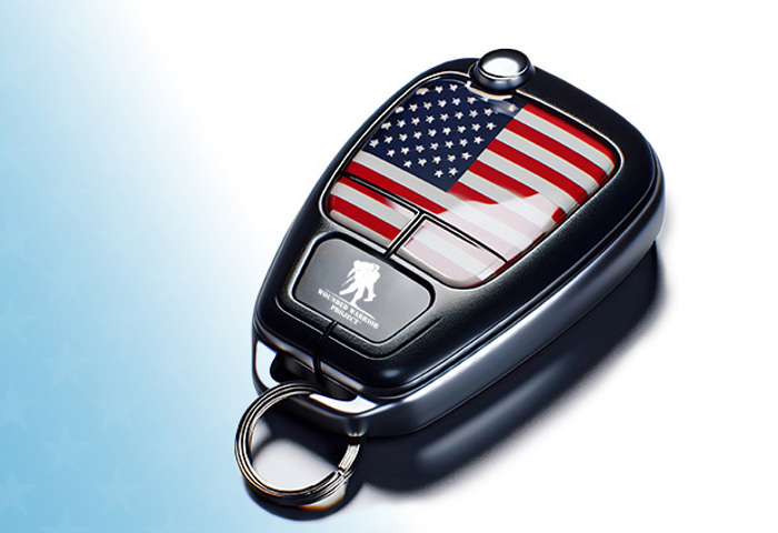 Key fob with American flag and WWP logo setting on a blue background with stars.
