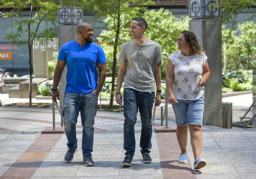 Three wounded warriors and veterans engaged in conversation.