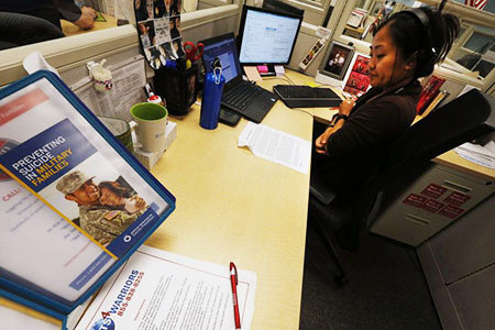 A veteran or family member answers a call at Vets4Warriors.