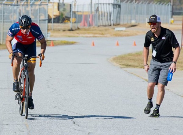 Si Wilson, an Army veteran and WWP Soldier Ride teammate, coaches a cyclist at Ft. Benning Regional Trials in 2017.