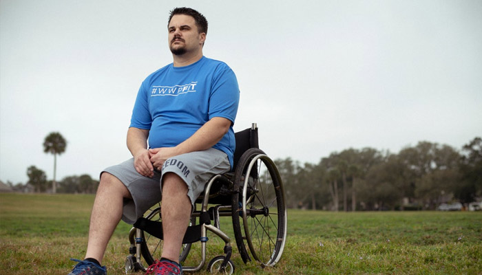 Wounded Warrior Chris Wolff overlooks a field 