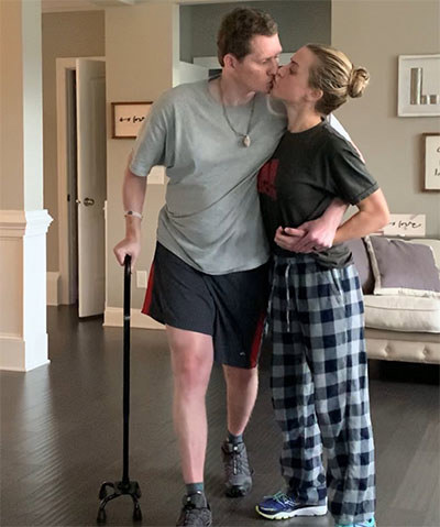 Veteran Jon Walker gets a kiss from his wife and caregiver Laura.