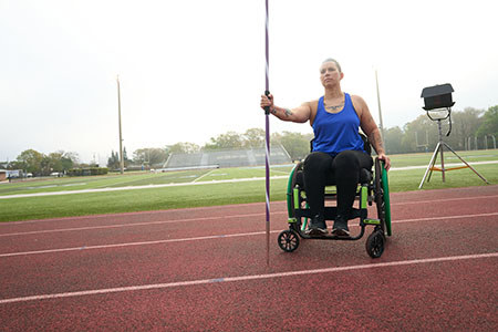 Army veteran Beth King throws a javelin from her wheelchair.