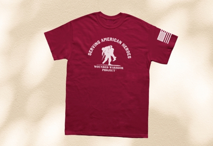 Tan background with a maroon T-shirt with a white WWP logo and serving American Heroes text on the front and a white American flag on the left sleeve.