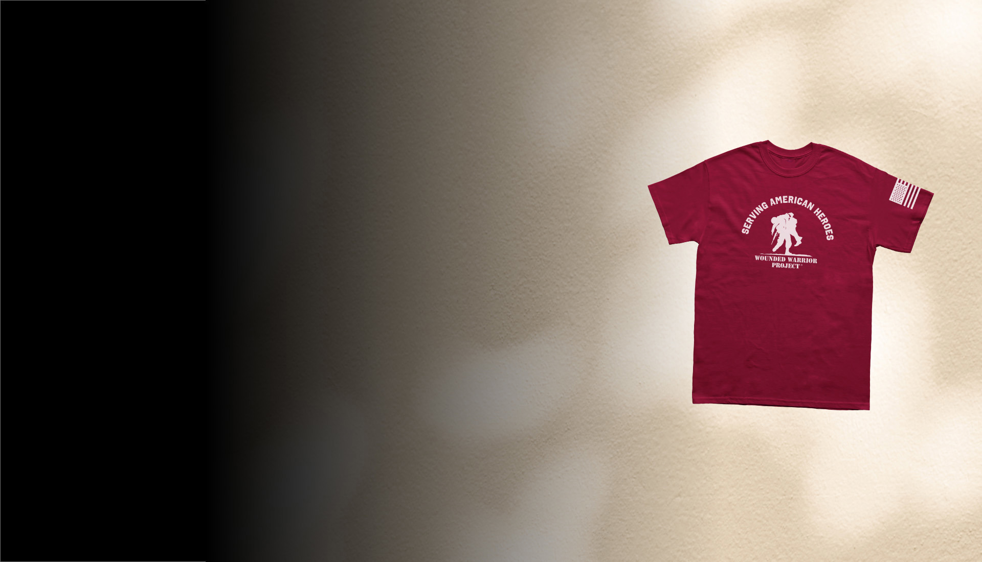Tan background with a maroon T-shirt with a white WWP logo and serving American Heroes text on the front and a white American flag on the left sleeve.