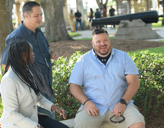 WWP warriors Danielle Green, Jason Major, and Jacob Norotsky talk outside.