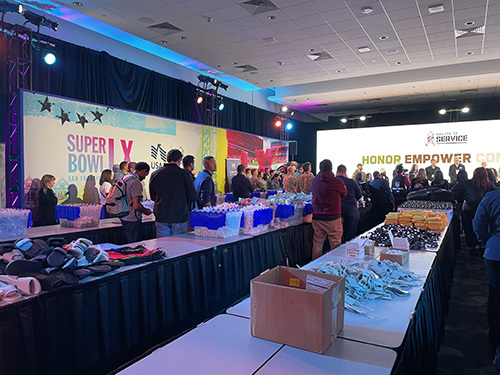 Volunteers pack WWP backpacks at the Super Bowl LX Experience in San Francisco.