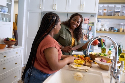 Warrior Yolanda Poullard and daughter in the kitchen cooking a healthy meal together