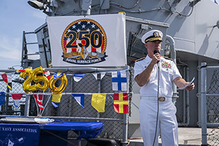 A Navy officer talks to sailors and guests during a celebration of the 250th birthday of the U.S. Navy in Los Angeles.