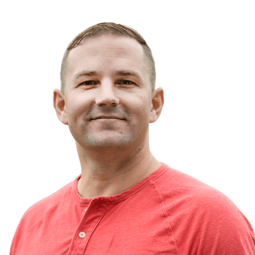 Warrior Mike Heller wearing a red short-sleeve shirt, standing outdoors.