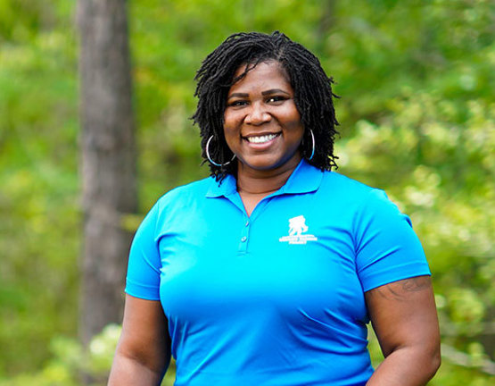 Wounded warrior Taniki Richard standing outside and smiling.