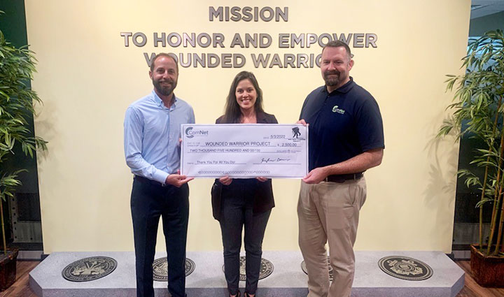 ComNet presenting a donation check to Wounded Warrior Project teammates