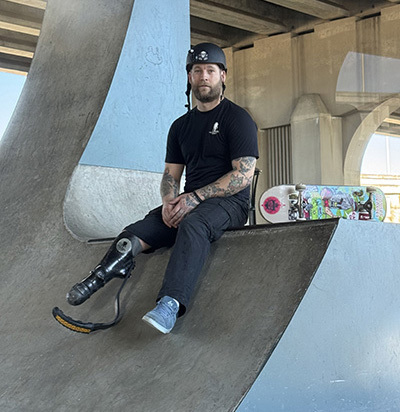 Adaptive skateboarder Harley Meagley sits at a skate park in Jacksonville, Florida.