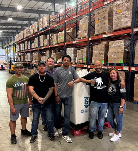 A group of veterans pose while volunteering at a community service project in Houston.