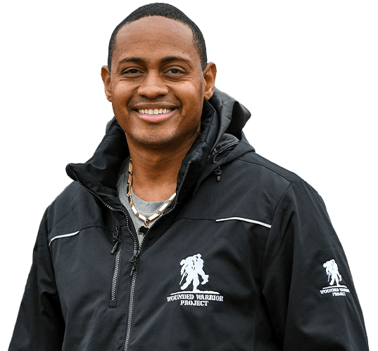 Warrior Tyshawn Jenkins wearing a black WWP jacket standing outdoors.