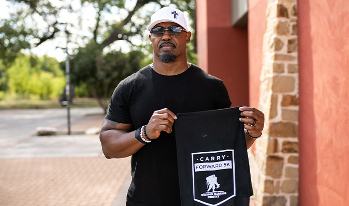 Former NFL player Brian Dawkins wears a white hat and black t-shirt before the San Antonio Carry Forward 5K.