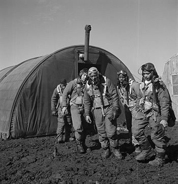 Tuskegee airmen leaving the parachute room in Ramitelli, Italy.