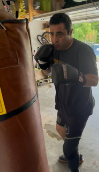 Sal hits his punching bag in the garage