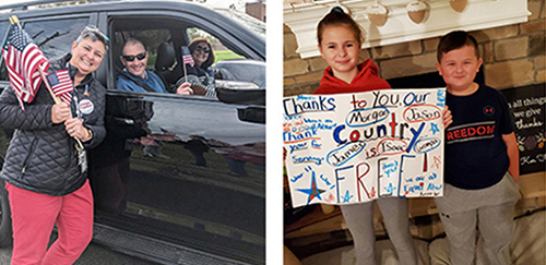 Teacher Heather Ker hands out flags during a Veterans Day parade.
