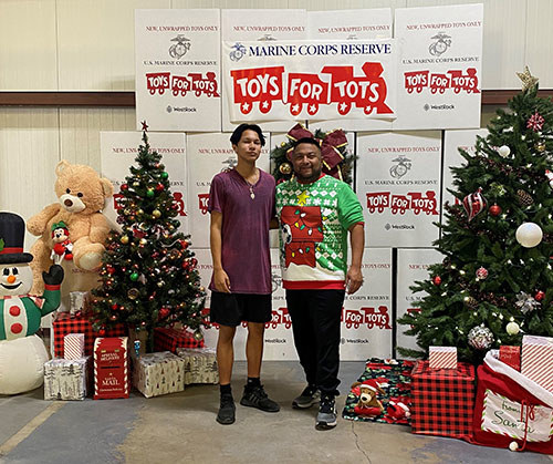 Marine veteran John Casares and son volunteer at a Toys For Tots event.