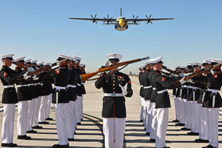 U.S. Marines execute a drill sequence during a Blue Angels’ flyover event.