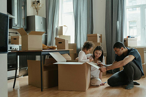 A family unpacking boxes in a new house.