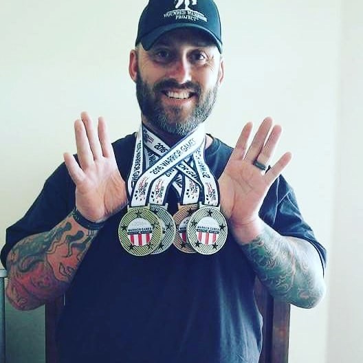 Army veteran Greg Quarles showcases his medals