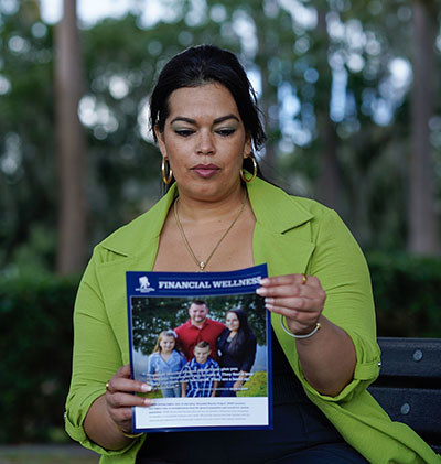 Woman warrior reading flyer about WWP's Financial Wellness programs.