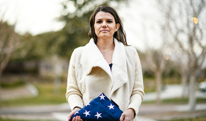 La veterana herida Melissa McMahon sostiene la bandera estadounidense