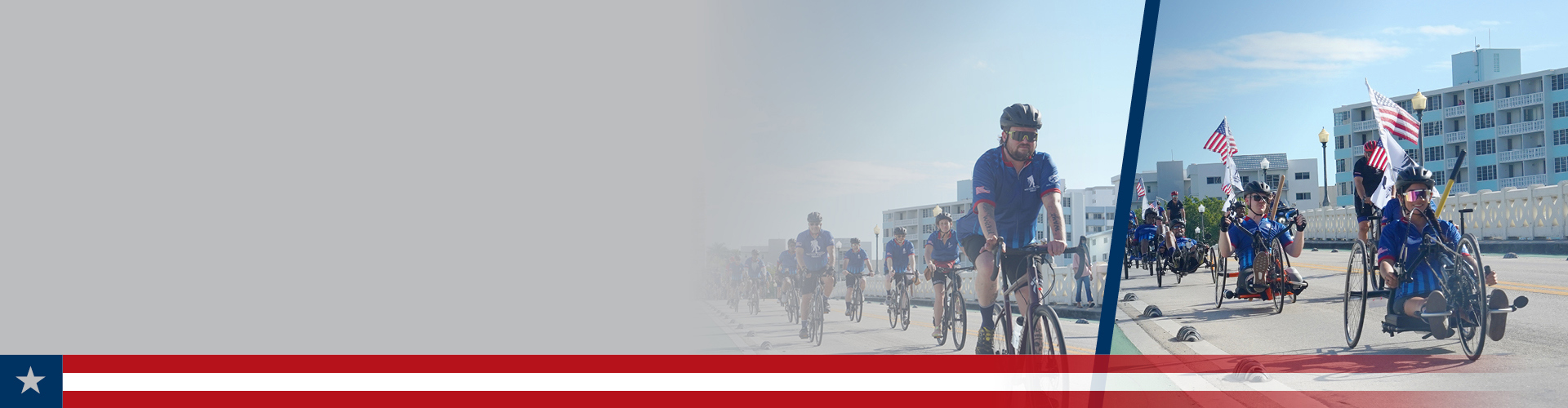 WWP Alumni ride road and adaptive bikes together along a sunny street with some carrying the American flag on their bikes.