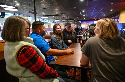 A group of warriors together having fun over a meal, laughing.